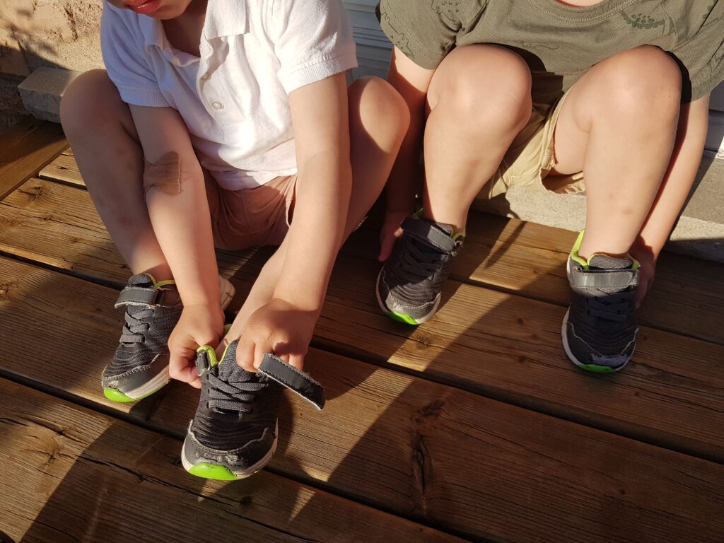 child learning to dress independently twins Montessori method