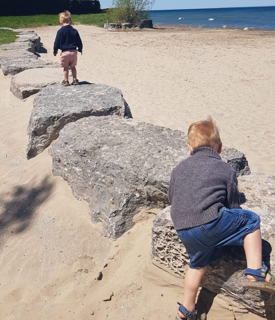 Montessori twins exploring independently outside